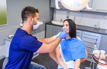 Dentist examining patient's smile