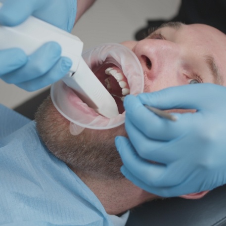 Dentist taking digital dental impressions of a patient