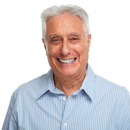 Senior man in button-up shirt standing and smiling